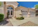 Lovely desert landscaping compliments the exterior of this home with a three-car garage at 467 Beardsley Cir, Henderson, NV 89052