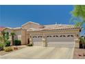 This charming home offers a spacious driveway leading to a three-car garage at 467 Beardsley Cir, Henderson, NV 89052