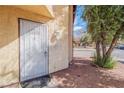 Secured front door with decorative bars, neutral desert landscaping and street view at 499 Kristin Ln, Henderson, NV 89011