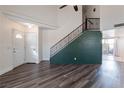 Open-concept living room with modern flooring, staircase and great natural lighting at 499 Kristin Ln, Henderson, NV 89011