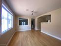 Bright living room featuring hardwood floors, abundant natural light, and open space to the other rooms at 5376 S Conquistador St, Las Vegas, NV 89148