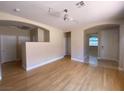 Bright living room featuring hardwood floors, abundant natural light, and open space to the other rooms at 5376 S Conquistador St, Las Vegas, NV 89148