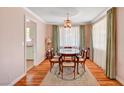 Traditional dining room featuring wood floors, a dark wood table, and classic decor at 557 6Th St, Boulder City, NV 89005