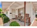 Inviting front porch features chairs, providing a cozy outdoor seating area with a nice curb appeal at 557 6Th St, Boulder City, NV 89005
