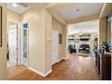 Bright hallway leading into the living room with hardwood floors and neutral paint at 5747 Jaborandi Ave, Pahrump, NV 89061