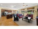 Open concept living area featuring hardwood floors, natural lighting, and comfortable furnishings at 5747 Jaborandi Ave, Pahrump, NV 89061