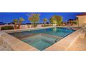 An elevated view of the backyard pool and spa combo showcases palm trees and lounge furniture at 6230 Calm Brook Ct, Las Vegas, NV 89149