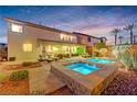 A serene backyard oasis with a sparkling pool, hot tub, and comfortable lounge area at 733 Secret London Ave, Las Vegas, NV 89178