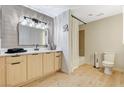 Bright bathroom featuring a vanity with modern fixtures, wooden accents, and a shower-tub combination at 8000 Badura Ave # 1007, Las Vegas, NV 89113