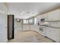 Bright kitchen features white cabinets, stainless steel appliances, and modern track lighting at 8333 Valley Stream Ave, Las Vegas, NV 89131