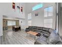 Spacious living room with high ceilings, many windows and vinyl flooring leading into the dining area at 8333 Valley Stream Ave, Las Vegas, NV 89131