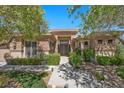 Charming single-story home boasts a stone facade, lush landscaping, and welcoming walkway at 9270 Valerie Elaine St, Las Vegas, NV 89139