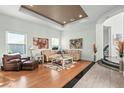 Bright living room featuring wood and tile flooring, neutral walls, and comfortable seating at 9301 Queen Charlotte Dr, Las Vegas, NV 89145