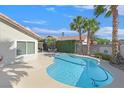 Gorgeous pool area features a refreshing swimming pool surrounded by ample patio space, lush plants and palm trees at , Henderson, NV 89074