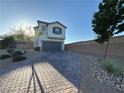 Charming two-story home features a two-car garage, brick driveway, and low-maintenance landscaping at 10148 Cluny Ave, Las Vegas, NV 89178