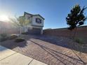 Charming two-story home features a two-car garage, brick driveway, and low-maintenance landscaping at 10148 Cluny Ave, Las Vegas, NV 89178