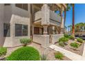 Attractive condo exterior with well-maintained landscaping, private patios, and convenient access to upper units at 1017 Falconhead Ln # 101, Las Vegas, NV 89128
