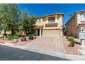 Lovely two-story home featuring a paved driveway, desert landscaping, and an attached two-car garage at 10908 Royal Highlands St, Las Vegas, NV 89141