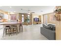 Spacious living room featuring a stone accent wall, tile flooring, and an open layout at 11764 Golden Moments Ave, Las Vegas, NV 89138