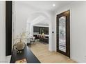 Elegant entryway with arched doorway, tiled floors, and a view into the kitchen and dining area at 11775 Woodbrook Ct, Las Vegas, NV 89141