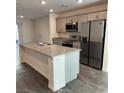 Modern kitchen with stainless steel appliances, gray cabinetry, and a large island at 12170 Midnight Pine Rd # 3, Las Vegas, NV 89183