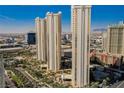 Striking daytime exterior view of a high-rise residential building in an urban setting against a beautiful blue sky at 135 E Harmon Ave # 2420, Las Vegas, NV 89109
