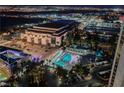 Aerial nighttime view showcasing a luxurious pool area and entertainment venue, perfect for upscale living at 135 E Harmon Ave # 2420, Las Vegas, NV 89109