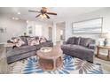 Bright living room featuring an area rug with blue accents and comfortable seating at 1512 Bellglen Dr, Las Vegas, NV 89128