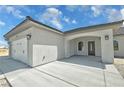 Close up view of the home's three car garage with a view of the front door at 1580 S Tiptop Trl, Pahrump, NV 89048