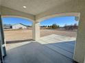 Covered front porch with arched columns overlooking land at 1580 S Tiptop Trl, Pahrump, NV 89048