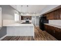Updated kitchen boasts granite countertops, modern appliances, and wood floors at 209 Camino Vista St, Henderson, NV 89012