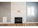 Cozy living room with decorative fireplace and white plantation shutters at 209 Camino Vista St, Henderson, NV 89012