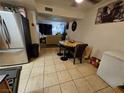Combined dining area with stainless steel refrigerator and views to the living room at 2200 Comet Ave # D, North Las Vegas, NV 89030