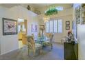 Cozy dining area with a glass table, patterned chairs, and an elegant chandelier at 2437 Desert Butte Dr, Las Vegas, NV 89134