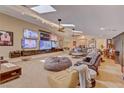 Spacious living room with skylights, multiple TVs, comfortable seating, and a relaxed atmosphere at 2500 Wimbledon Dr, Las Vegas, NV 89107