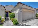 Inviting home exterior with a cozy entryway, desert landscaping, and a two-car garage at 2687 Ivoryhill St, Las Vegas, NV 89135