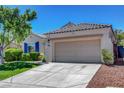 Charming single-story home featuring desert landscaping, blue shutters, and a two-car garage at 2687 Ivoryhill St, Las Vegas, NV 89135