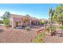 Landscaped backyard showcases desert flora, gravel, and a covered patio at 3013 Sungold Dr, Las Vegas, NV 89134