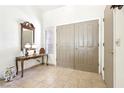 Tiled entryway with decorative mirror, lamps, console table, and double doors at 3013 Sungold Dr, Las Vegas, NV 89134