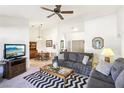 Inviting living room with neutral decor, ceiling fan, and seamless transition to dining area at 3013 Sungold Dr, Las Vegas, NV 89134