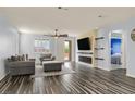 Comfortable living room with ceiling fan, fireplace, TV, and outdoor access at 3096 Beaux Art Ave, Henderson, NV 89044