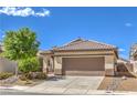 Charming single-story home featuring a well-maintained front yard and a two-car garage at 344 Golden Shore Dr, Las Vegas, NV 89123