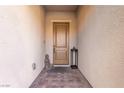 View of the front door with a small Buddha statue and decorative lantern on a brick pathway at 3929 Reyes Ave, Las Vegas, NV 89141