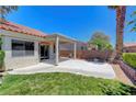 A covered back patio for outdoor living and entertaining, featuring a well-manicured lawn and a block wall at 4197 Bottiglia Ave, Las Vegas, NV 89141