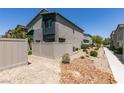 The backyard features low-maintenance landscaping, a fence and a view of the home's back exterior at 4519 Sapphire Moon Ave, North Las Vegas, NV 89084