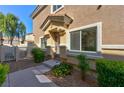 Inviting front entrance with a well-maintained walkway, manicured bushes, and a charming covered porch at 4779 Straight Flush Dr # 103, Las Vegas, NV 89122