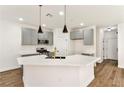 Stylish kitchen featuring stainless steel appliances, a breakfast bar, pendant lighting and grey cabinets at 4779 Straight Flush Dr # 103, Las Vegas, NV 89122