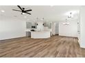 Spacious open floor plan with wood-look floors leading to the kitchen, and bright lighting at 4779 Straight Flush Dr # 103, Las Vegas, NV 89122