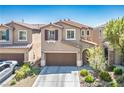 Charming home featuring a two-car garage, landscaped front yard, and a delightful facade at 4786 Castel Martini Ct, Las Vegas, NV 89147