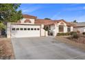 Inviting single-story home with a well-manicured lawn and spacious driveway at 5020 Linkside Dr, Las Vegas, NV 89130